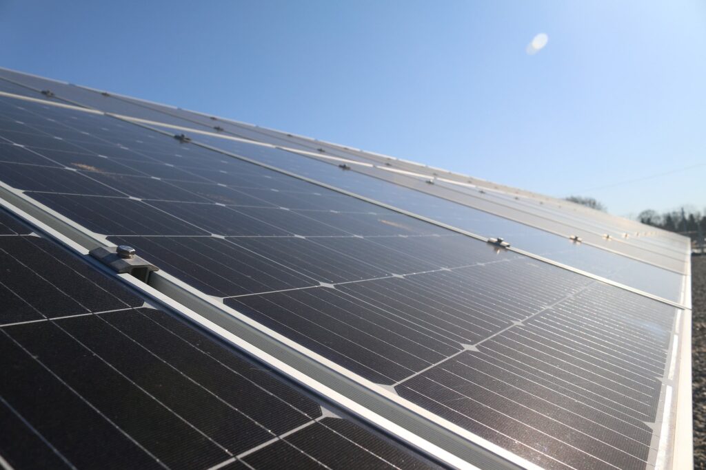 Modern solar panels under a clear blue sky, highlighting the benefits of solar installations for energy efficiency and sustainability.