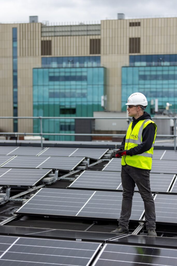 A solar installer conducting maintenance on solar panels, ensuring the proper functioning of a solar system for optimal energy efficiency.